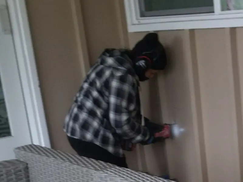 Professional electrician installing an exterior outlet in Baldwin