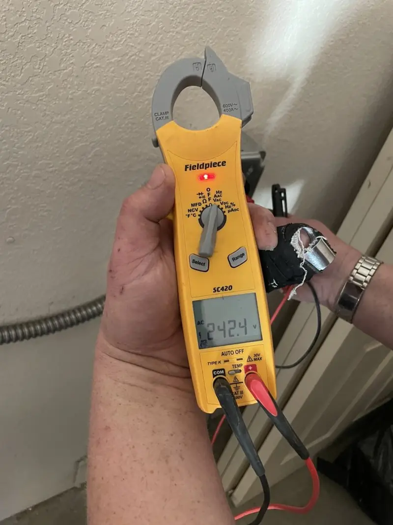 Voltage testing with clamp meter during Outlet Installation in Baldwin